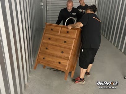 Open storage unit with boxes and furniture being loaded for cleanout in Richmond, VA